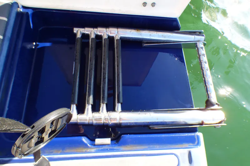 Slide: The Image of Stainless steel swim ladder on 2018 Chaparral 267 SSX boat, folded on blue platform. - 28