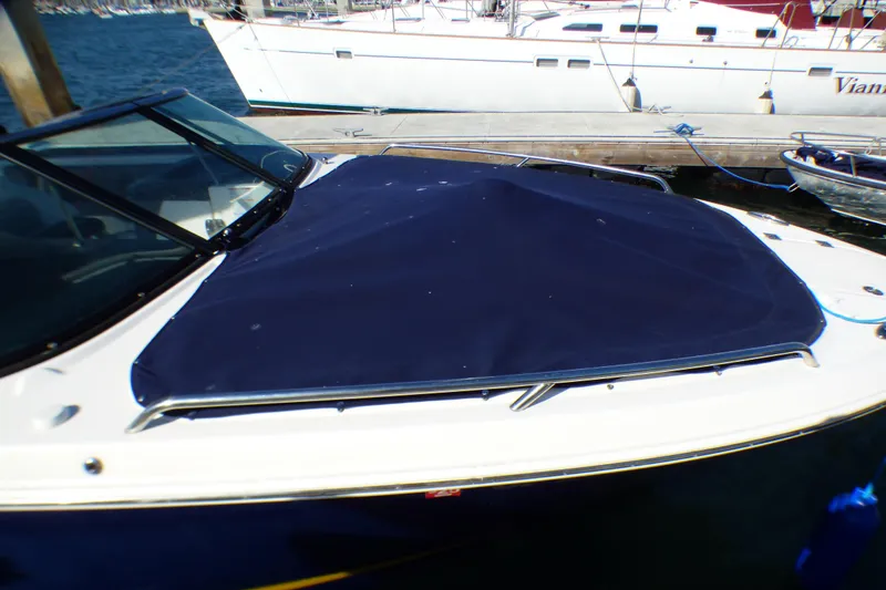 Slide: The Image of 2018 Chaparral 267 SSX boat with blue cover docked at marina. - 8