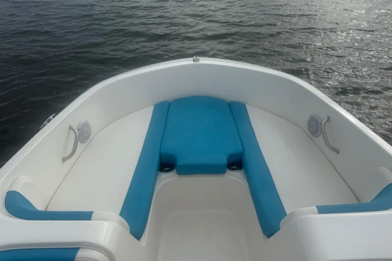 Slide: The Image of 2022 Bayliner Element E18 boat interior with blue and white seating on water. - 11