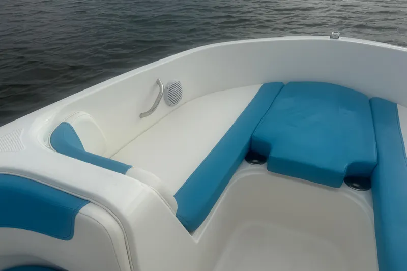 Slide: The Image of 2022 Bayliner Element E18 boat interior with blue and white seating on water. - 13