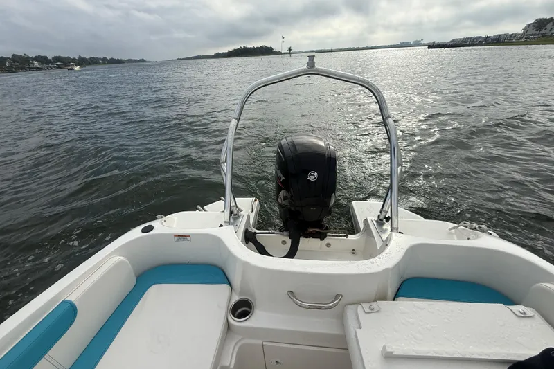 Slide: The Image of 2022 Bayliner Element E18 boat on water, rear view with motor and seating. - 19