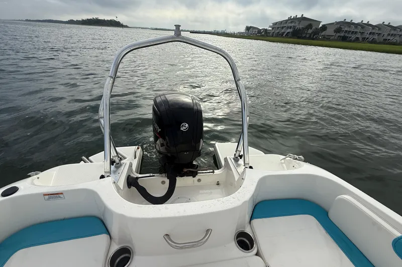 Slide: The Image of 2022 Bayliner Element E18 boat on water, rear view with motor and seating. - 22