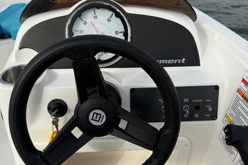 Slide: The Image of 2022 Bayliner Element E18 dashboard with steering wheel and instrument panel. - 24