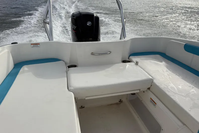 Slide: The Image of 2022 Bayliner Element E18 boat interior with seating and Mercury outboard motor. - 28