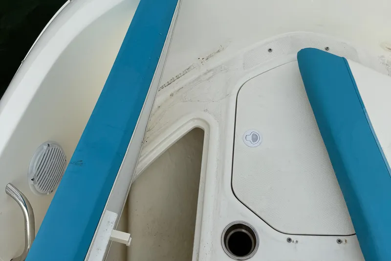 Slide: The Image of 2022 Bayliner Element E18 boat interior with blue seating and storage compartment. - 30