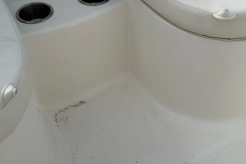 Slide: The Image of Interior seating area of a 2022 Bayliner Element E18 boat, featuring cup holders. - 32