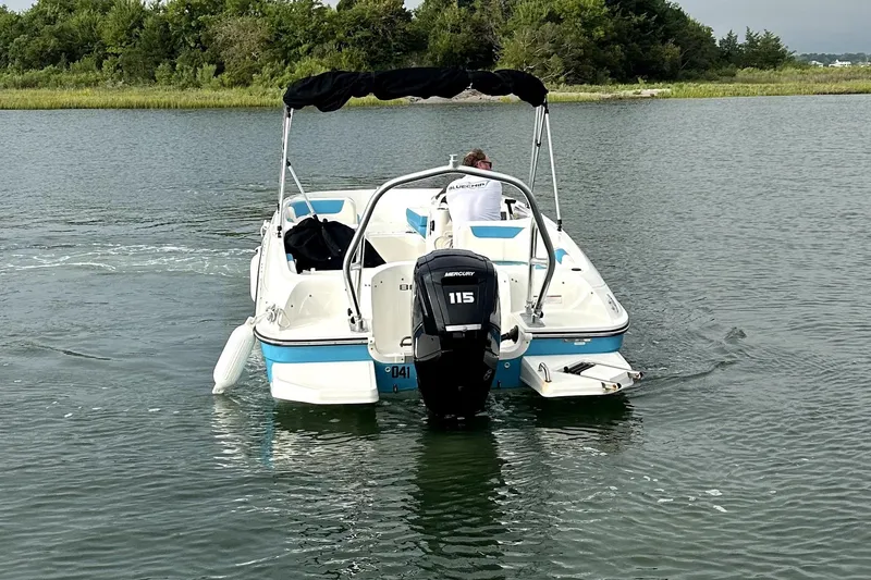 Slide: The Image of 2022 Bayliner Element E18 boat cruising on a calm lake. - 37