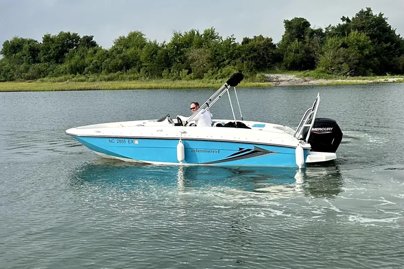 Slide: The Image of 2022 Bayliner Element E18 boat cruising on a calm lake. - 6