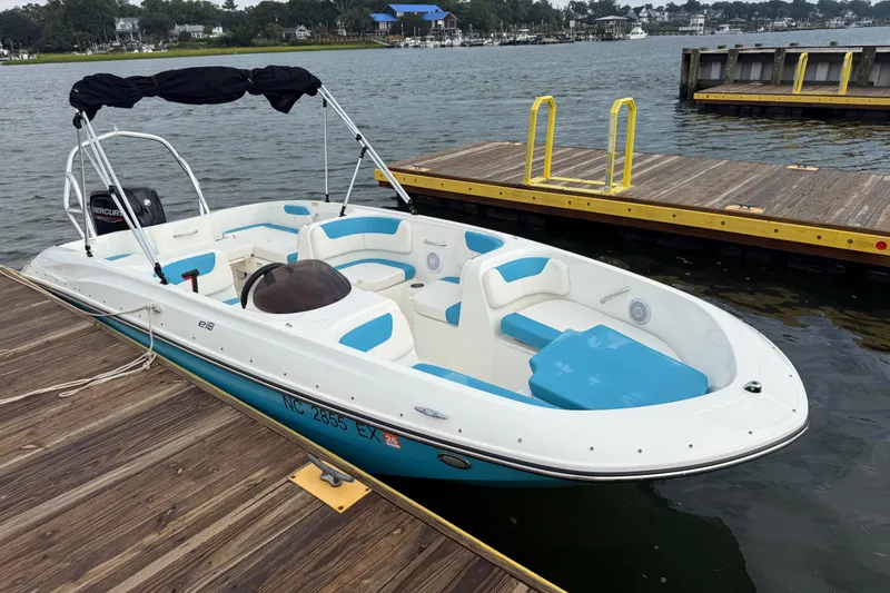 Slide: The Image of 2022 Bayliner Element E18 boat docked on a calm lake. - 9