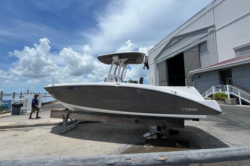 The Image of 2022 Yamaha Boats 252 FSH Sport on dock, with cloudy sky background. - 0
