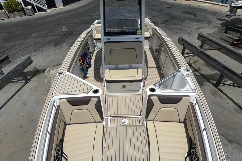 Slide: The Image of 2022 Yamaha Boats 252 FSH Sport interior with beige seating and sleek design. - 12