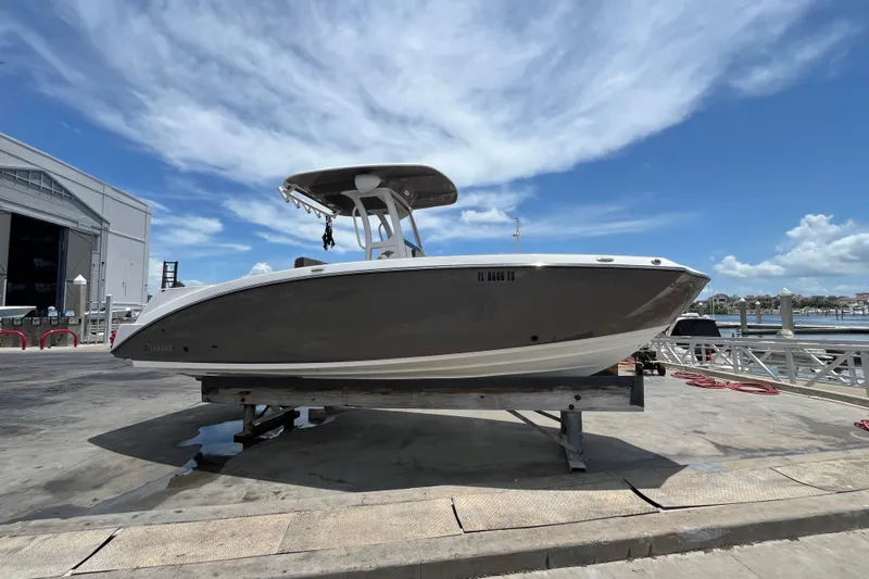 Slide: The Image of 2022 Yamaha Boats 252 FSH Sport on dock under blue sky. - 2