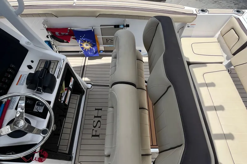 Slide: The Image of 2022 Yamaha Boats 252 FSH Sport interior with steering wheel and seating. - 6