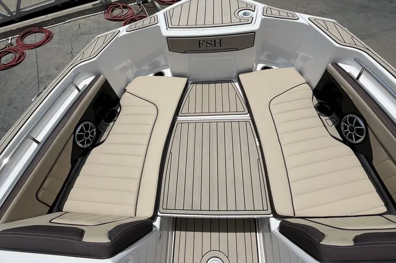 Slide: The Image of 2022 Yamaha Boats 252 FSH Sport interior with beige seating and sleek design. - 7