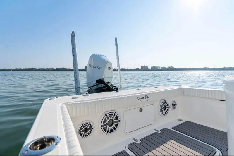 Slide: The Image of 2021 Canyon Bay 24H boat with Mercury engine on calm water. - 11