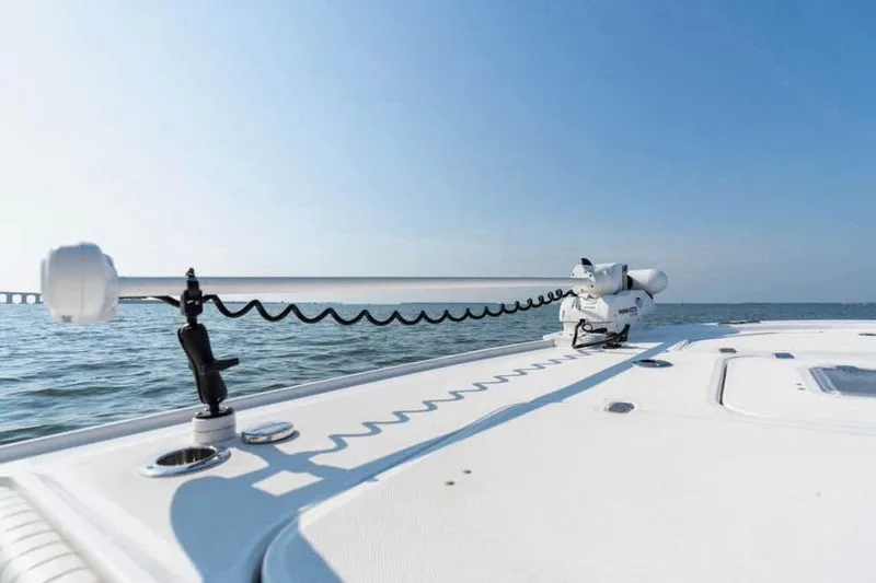 Slide: The Image of 2021 Canyon Bay 24H boat deck with trolling motor on calm water. - 2