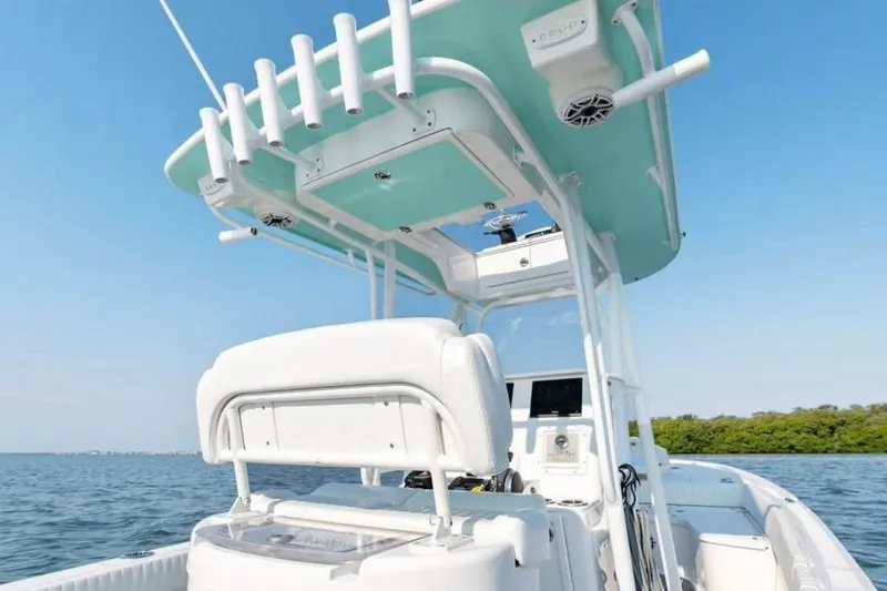 Slide: The Image of 2021 Canyon Bay 24H boat with T-top, on calm water under clear sky. - 3