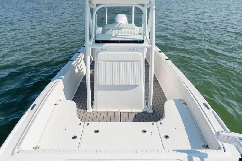 Slide: The Image of 2021 Canyon Bay 24H boat on water, showcasing spacious deck and seating area. - 4