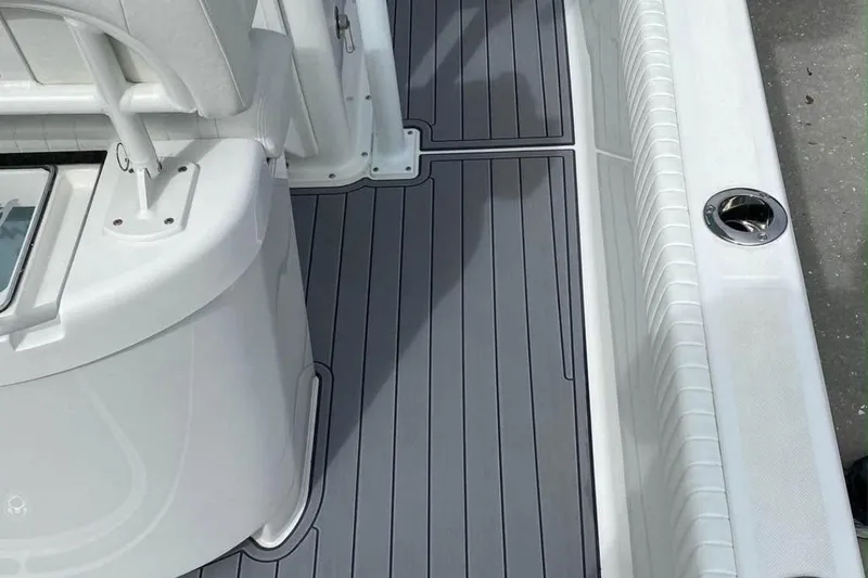 Slide: The Image of 2021 Canyon Bay 24H boat interior with sleek gray flooring and white seating. - 5