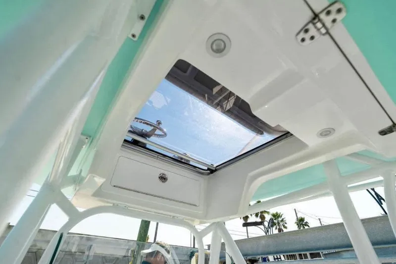 Slide: The Image of 2021 Canyon Bay 24H boat interior with open hatch and steering wheel. - 6