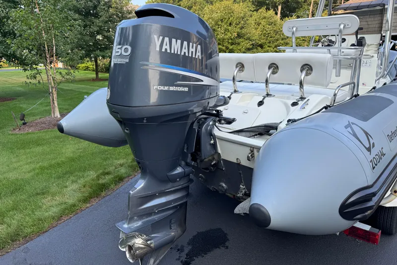 Slide: The Image of Zodiac Pro Open 650 boat with Yamaha 150 four-stroke engine, 2010 model, parked on driveway. - 12