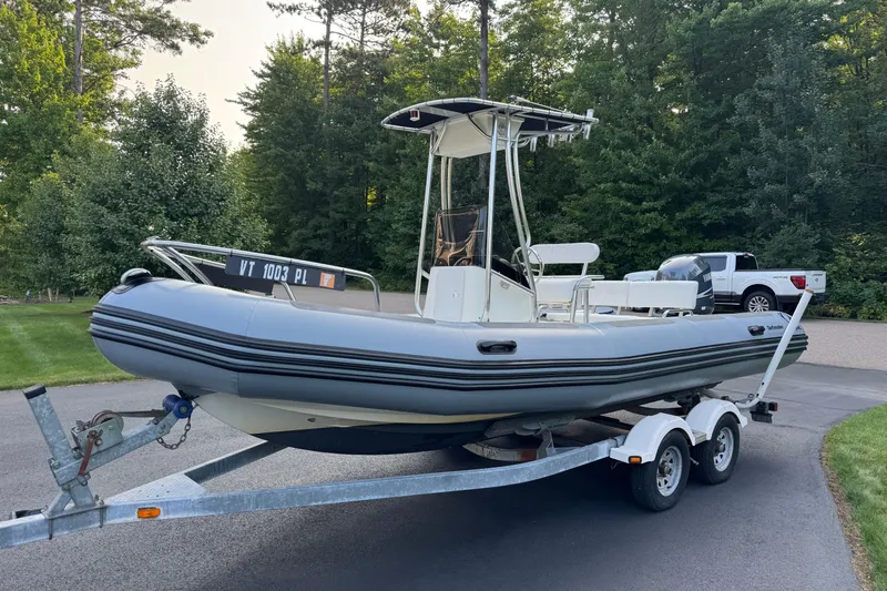 Slide: The Image of 2010 Zodiac Pro Open 650 boat on trailer, parked in a wooded area. - 4