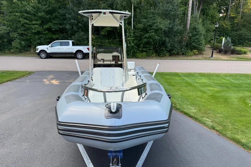 Slide: The Image of 2010 Zodiac Pro Open 650 boat on trailer, parked on driveway near green lawn. - 5