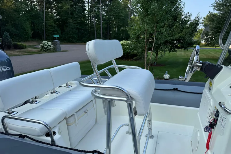 Slide: The Image of 2010 Zodiac Pro Open 650 boat interior with white seating and steering wheel. - 8