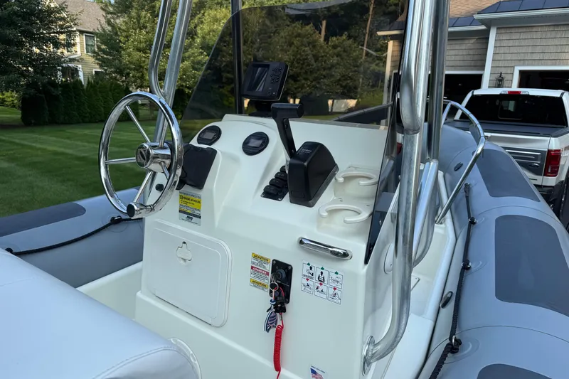 Slide: The Image of 2010 Zodiac Pro Open 650 boat console with steering wheel and controls. - 9