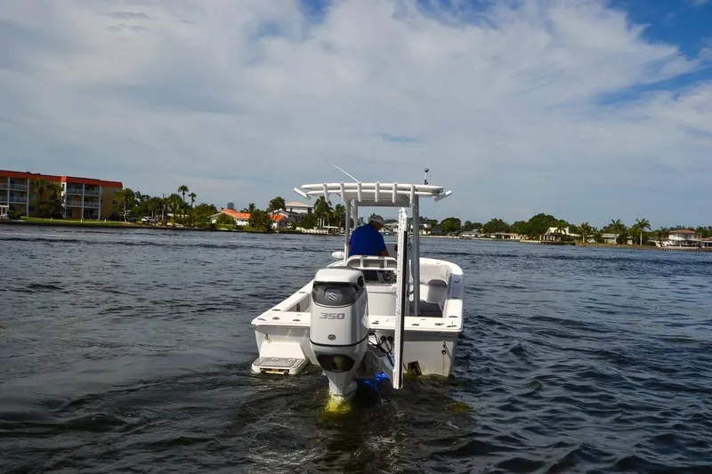 Slide: The Image of 2020 Canyon Bay 28h boat cruising on a scenic waterway under a partly cloudy sky. - 18