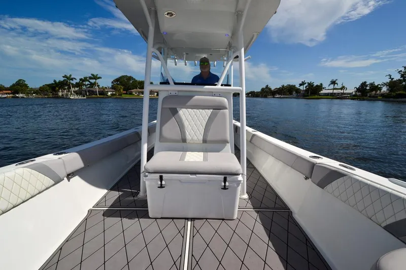 Slide: The Image of 2020 Canyon Bay 28h boat on water, featuring sleek interior and scenic backdrop. - 2