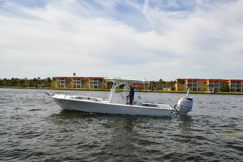 Slide: The Image of 2020 Canyon Bay 28h boat on water near colorful waterfront buildings. - 21