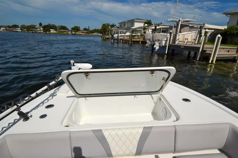 Slide: The Image of 2020 Canyon Bay 28h boat with open storage compartment on calm waters. - 26