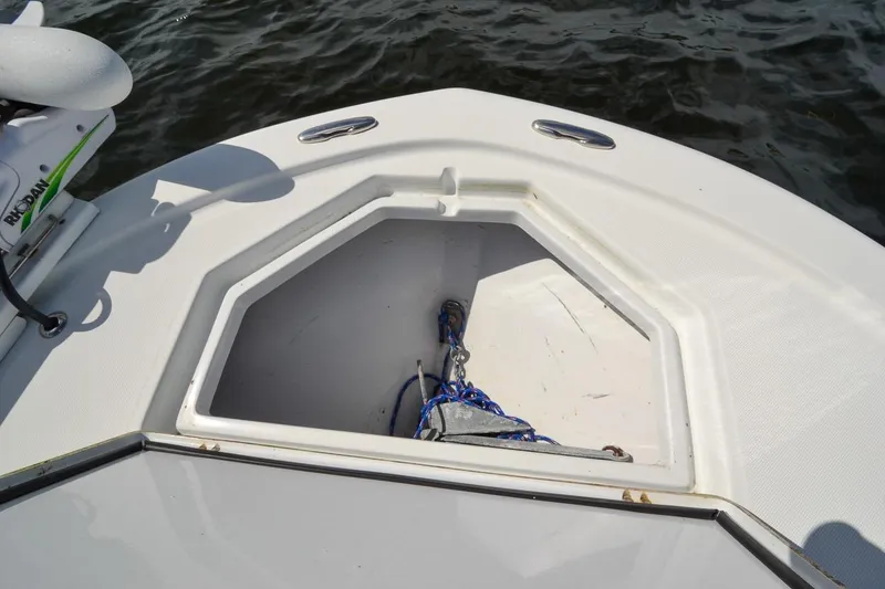 Slide: The Image of Bow storage compartment on a 2020 Canyon Bay 28h boat, featuring anchor and rope. - 27