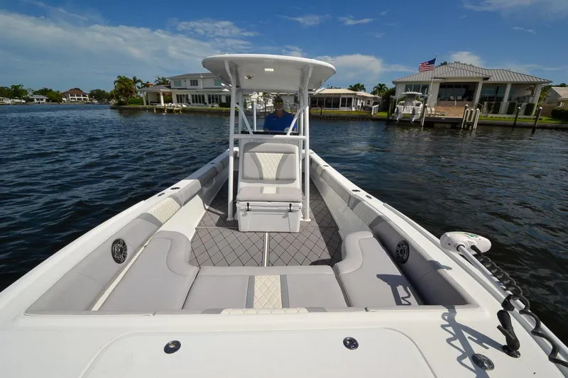 Slide: The Image of 2020 Canyon Bay 28h boat on water, featuring spacious seating and modern design. - 28
