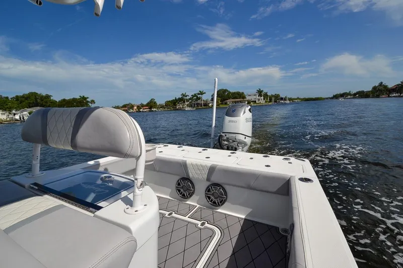 Slide: The Image of 2020 Canyon Bay 28h boat on a scenic waterway, featuring a powerful Suzuki engine. - 3
