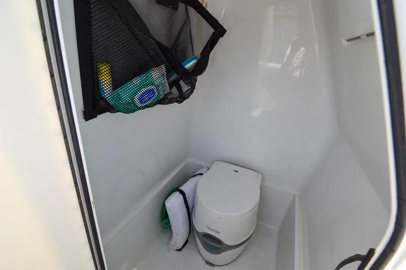 Slide: The Image of Compact bathroom in 2020 Canyon Bay 28h boat with portable toilet and storage. - 30