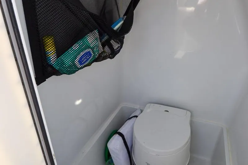 Slide: The Image of Portable toilet inside 2020 Canyon Bay 28h boat with storage net. - 31
