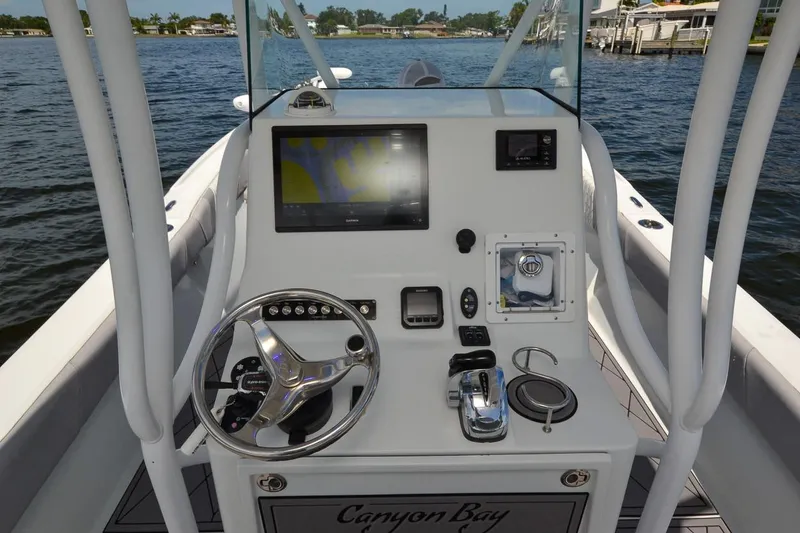 Slide: The Image of Cockpit of 2020 Canyon Bay 28h boat with steering wheel and navigation display. - 33