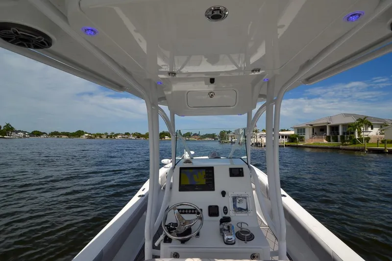 Slide: The Image of 2020 Canyon Bay 28h boat interior with navigation system on a sunny day. - 35