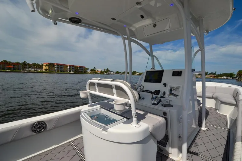 Slide: The Image of 2020 Canyon Bay 28h boat interior with helm, on a scenic waterway. - 36