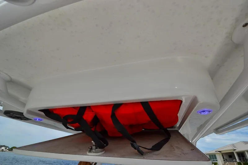 Slide: The Image of Storage compartment on 2020 Canyon Bay 28h boat with red life jacket. - 37