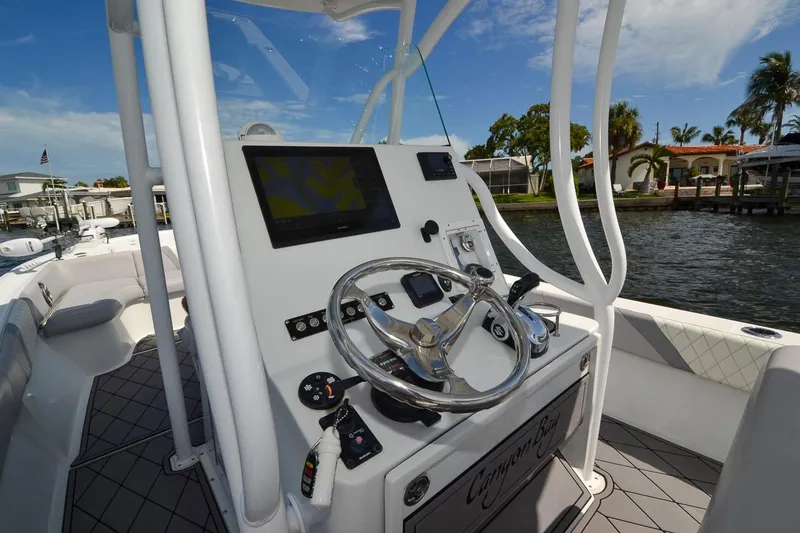 Slide: The Image of 2020 Canyon Bay 28h boat helm with steering wheel and navigation display. - 39