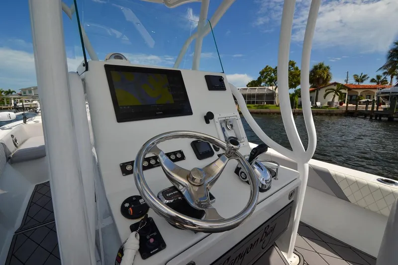 Slide: The Image of Helm of 2020 Canyon Bay 28h boat with steering wheel and navigation display. - 4
