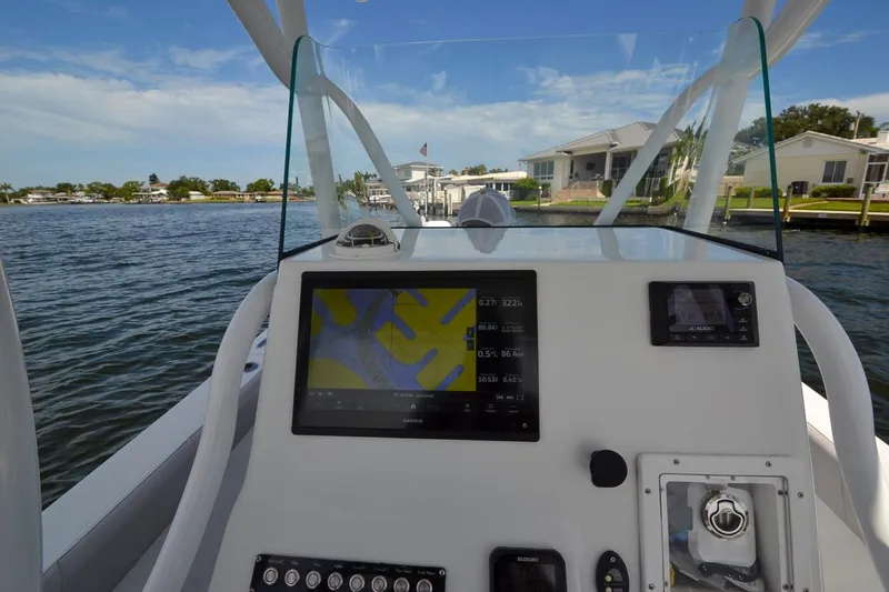 Slide: The Image of Canyon Bay 28h 2020 boat dashboard with navigation screen on a sunny day. - 40