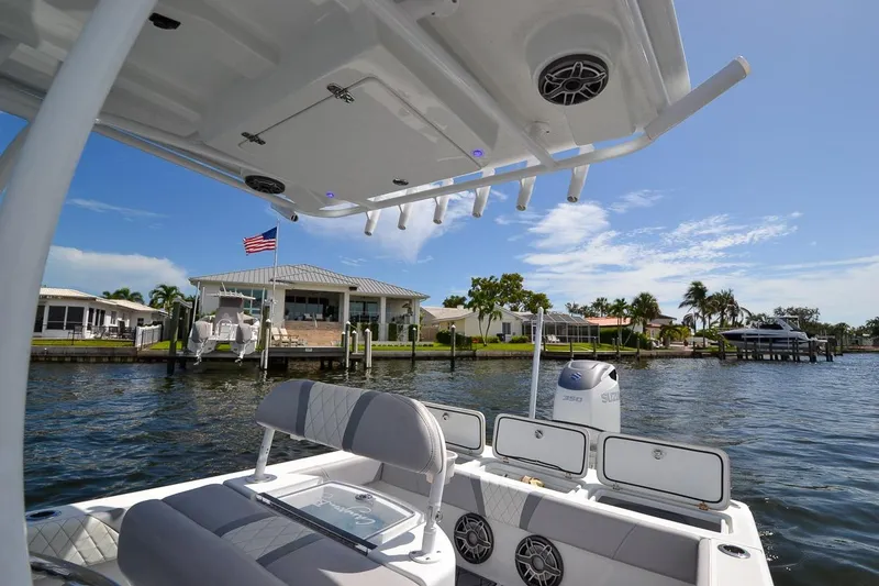 Slide: The Image of 2020 Canyon Bay 28h boat on water near waterfront homes, under clear blue sky. - 43