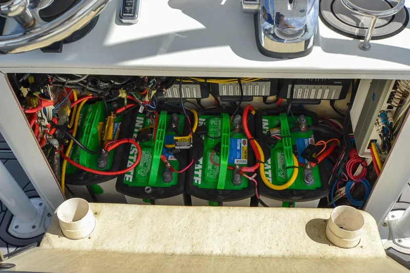 Slide: The Image of Battery compartment of a 2020 Canyon Bay 28h boat, featuring multiple green batteries and wiring. - 48