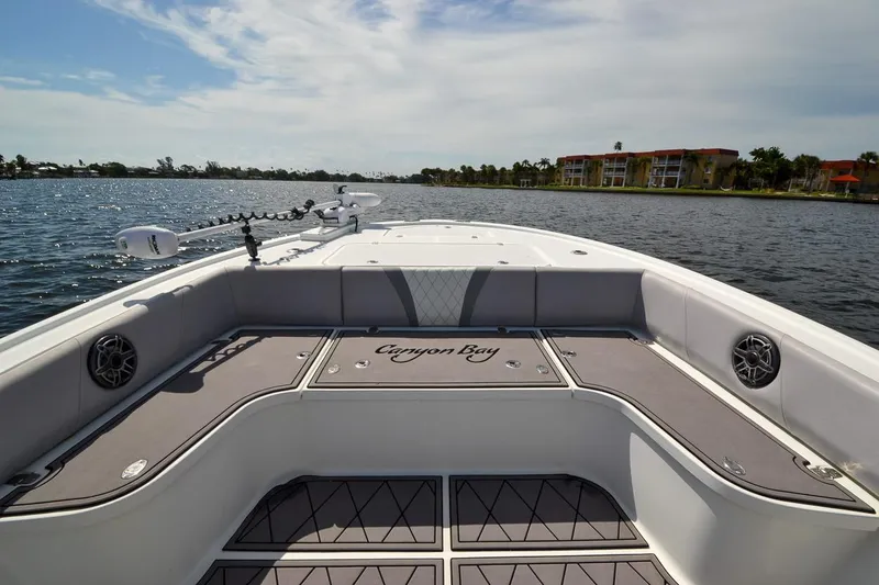 Slide: The Image of 2020 Canyon Bay 28h boat interior with seating, speakers, and water view. - 6
