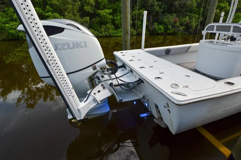 Slide: The Image of 2020 Canyon Bay 28h boat with Suzuki outboard motor, docked on calm water. - 8