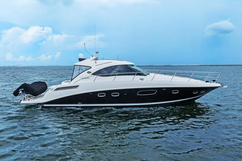 Slide: The Image of 2012 Sea Ray 470 Sundancer yacht cruising on open water under a clear sky. - 0